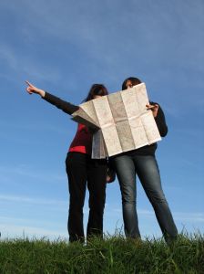 Two women lost, one pointing, the other holding a map.